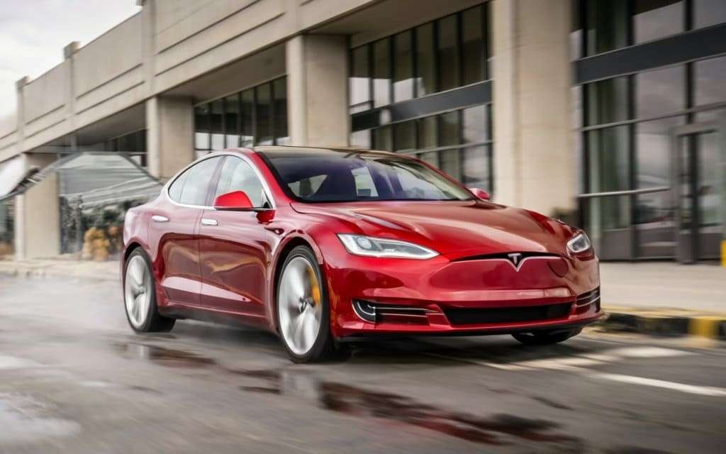 a beautiful red-colored tesla car